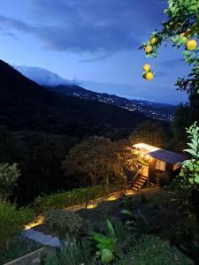 a view of a mountain at night at Entre Arboles Cali in Cali