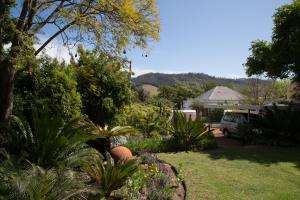 a garden with a van parked in a yard at 22 Van Wijk Street Tourist Accommodation in Franschhoek