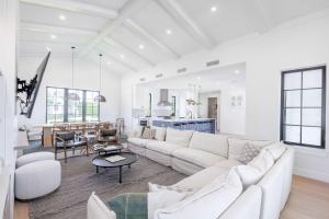 a white living room with a white couch and a table at Brand New Build Larkshine House - Pool in Key West
