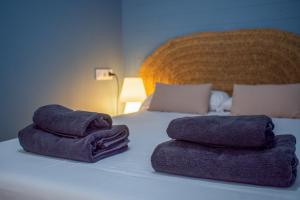 two towels sitting on top of a bed at TrendyHomes Neptuno Mojacar in Mojácar +6 photos