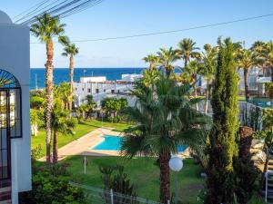 a view of a resort with a pool and palm trees at TrendyHomes Neptuno Mojacar in Mojácar