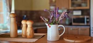 a table with a vase filled with purple flowers and a vase at Srub pod Tetřevím vrchem in Dolni Dvur +32 photos