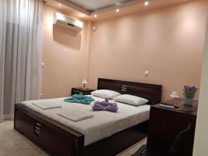 a bedroom with a bed with two towels on it at Aurora - Close to Macedonia Airport in Kardiá