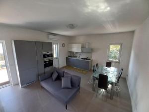 un soggiorno con un divano blu e un tavolo di Villa Amalia - condominium private beach a San Felice Circeo
