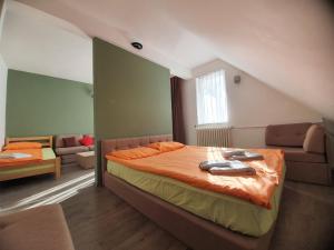 a bedroom with a bed and a couch in a room at Hotel Arena - Teteks in Tetovo +32 photos
