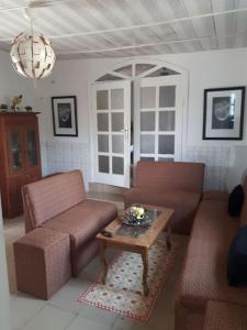 a living room with two chairs and a coffee table at Résidence LIBOUGA - Edéa I in Edéa