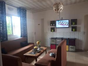 a living room with two couches and a tv at Résidence LIBOUGA - Edéa I in Edéa