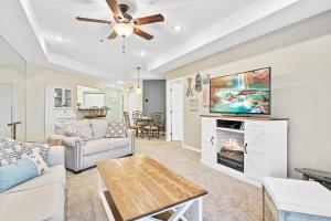 a living room with a couch and a tv at Emerald Bay Overlook Breathtaking Views, Pools in Lake Ozark