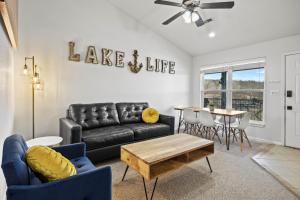 a living room with a black leather couch and a table at 40 Lighthouse Rd. Unit 3-402 in Lake Ozark