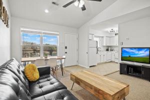 a living room with a couch and a tv and a table at 40 Lighthouse Rd. Unit 3-402 in Lake Ozark