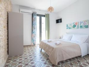 a bedroom with a large bed and a large window at Heraklions Heart Apartment in Heraklio Town