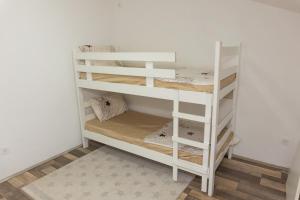 a white bunk bed in a room at Cozy Modern Apartment in Gevgelija