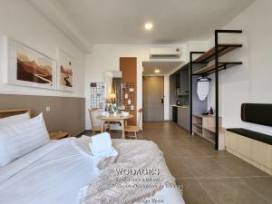 a bedroom with a bed and a table in it at Mossaz at Empire Damansara by Wodages in Kuala Selangor