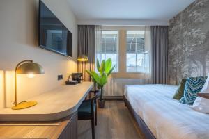 Postel nebo postele na pokoji v ubytování Leonardo Hotel Breda City Center