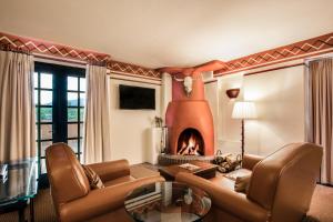 a living room with a couch and a fireplace at Inn & Spa at Loretto in Santa Fe