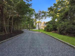 an empty road in front of a house at The President Mansion Luxurious 7BR Family Retreat home in Bay Shore +38 photos