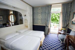 Postel nebo postele na pokoji v ubytování Carlton Lausanne Boutique Hôtel