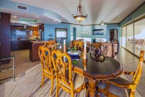 a dining room and kitchen with a table and chairs at Spacious 4 bedroom Condo with expansive Ocean Views and luxurous features - #910 Sonoran Sky - RP Vacation in Puerto Peñasco