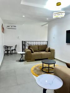 a living room with a couch and a table at Bilak Luxury Apartments & Homes Ltd in Abuja