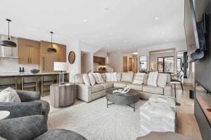 a living room with a couch and a table at One Riverfront Townhome 05 by East West Hospitality in Avon