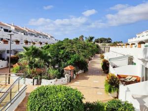 a balcony of a building with trees and plants at Amantes del Mar, Heated pool in Costa Del Silencio