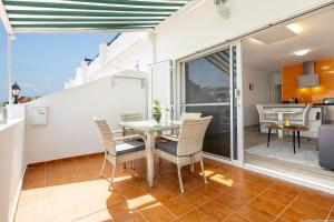 a kitchen and dining room with a table and chairs at Amantes del Mar, Heated pool in Costa Del Silencio