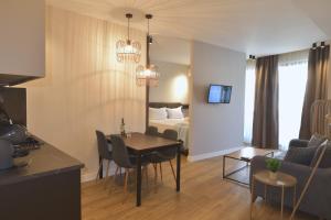 a living room with a room with a bed and a table at Feel Athens Studios at Monastiraki in Athens