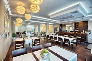 a restaurant with tables and chairs and a bar at Hotel Azyl in Kąty Wrocławskie