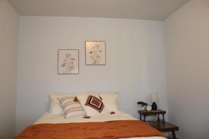 a bedroom with a bed with two pictures on the wall at Stony Lane Retreat in Clare