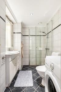 Un baño con inodoro, lavabo y ducha. en Exclusive and spacious apartment in city center, en Oslo