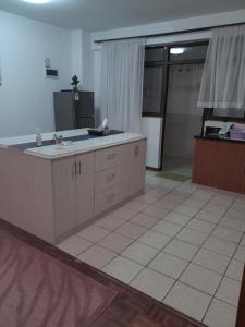 a large kitchen with a sink and a door to a garage at Faharihill place in Nairobi