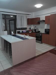 a kitchen with a large island in the middle at Faharihill place in Nairobi
