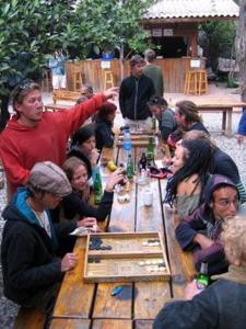 a group of people sitting around a wooden table at Bayrams Tree Houses in Olympos