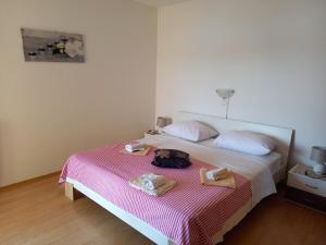 a bedroom with a bed with towels on it at LEVANDA in Supetarska Draga