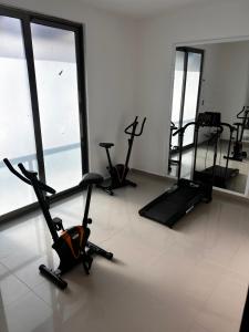 ein Fitnessstudio mit Cardio-Fahrrädern und Ellipsentrainern in einem Raum in der Unterkunft Hermoso Penthouse in Tuxtla Gutiérrez