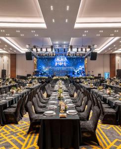 a large banquet hall with long tables and chairs at GRAND SAPPHIRE HOTEL CASINO and RESIDENTS 1 Bedroom Suit with Superior Sea View and Free Internet in Áyios Yeórgios +38 photos