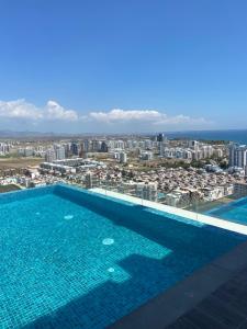 a swimming pool with a view of a city at GRAND SAPPHIRE HOTEL CASINO and RESIDENTS 1 Bedroom Suit with Superior Sea View and Free Internet in Áyios Yeórgios