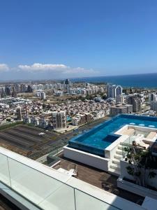 a view from the roof of a building with a swimming pool at Grand Sapphire Resort Casino and Residence 20 Floor Superb Sea View in Saint Yeorgios