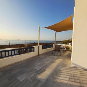 a balcony with a view of the ocean at Lofos Studios in Agios Prokopios