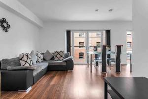 a living room with a couch and a table at Seagate Heights Large, Stylish, City Centre Flat in Dundee