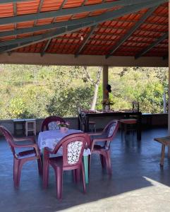a table and chairs on a patio with a table at CANTINHO DA ROSA ac - RIO PRIVATIVO in Manhã