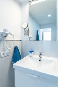 a bathroom with a white sink and a mirror at Bellavista in Tías +10 photos