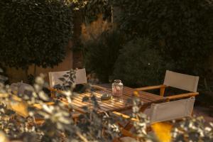 a table with two chairs and a candle on it at Mansion Argyrakiko - 3 bedroom house in Kampos in Chios