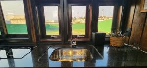 a bathroom with a sink with a view of a field at Recanto AlceNegro in Miguel Pereira