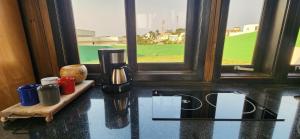 a coffee maker sitting on a counter next to a window at Recanto AlceNegro in Miguel Pereira