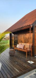 a bed on a wooden deck with a swing at Recanto AlceNegro in Miguel Pereira