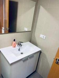 a bathroom with a white sink and a mirror at Casa Mercaderes in Logroño