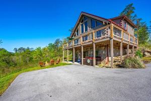 a large wooden house with a driveway in front of it at Good Times 2 - Family Lodge-Fire Pit, Theater, Hot Tub & Pool Table in Sevierville +61 photos