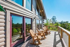 a porch with rocking chairs and windows on a house at Good Times 2 - Family Lodge-Fire Pit, Theater, Hot Tub & Pool Table in Sevierville