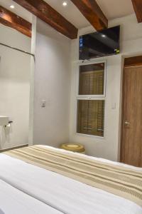 Ένα ή περισσότερα κρεβάτια σε δωμάτιο στο Casa Helena Hostel